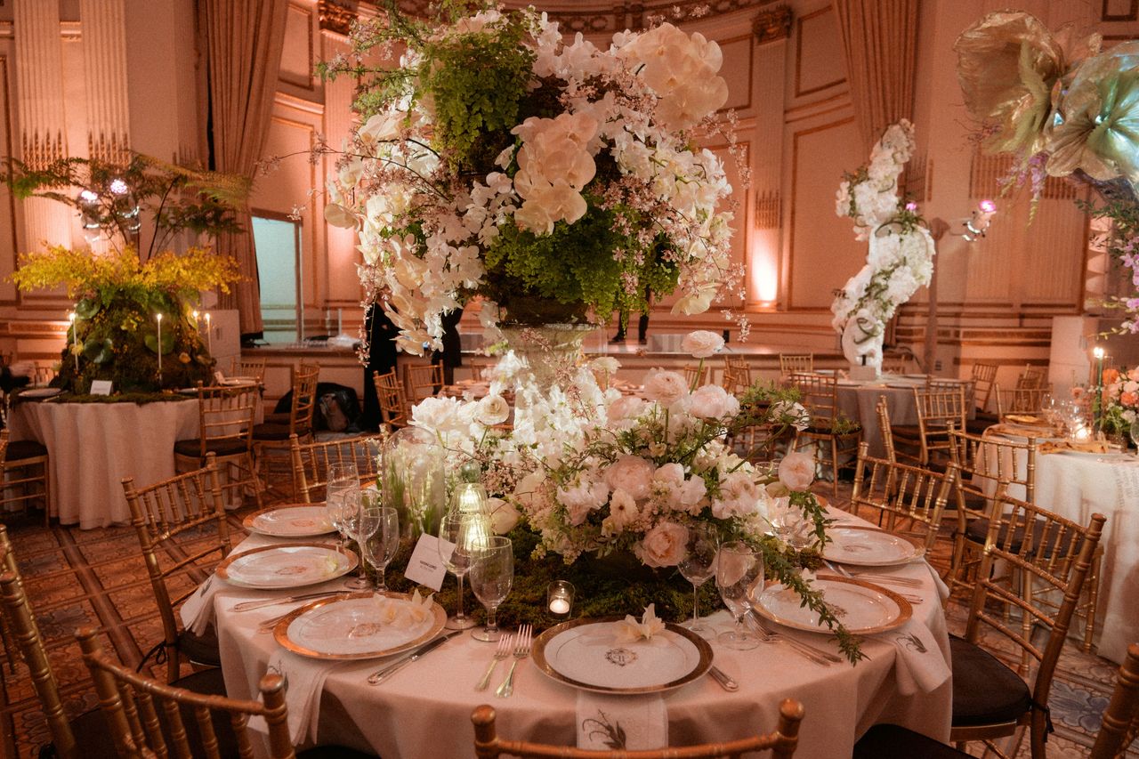 A gorgeous table we designed for the New York Botanical Garden Orchid Dinner 2024, including lush greenery and gold place settings.