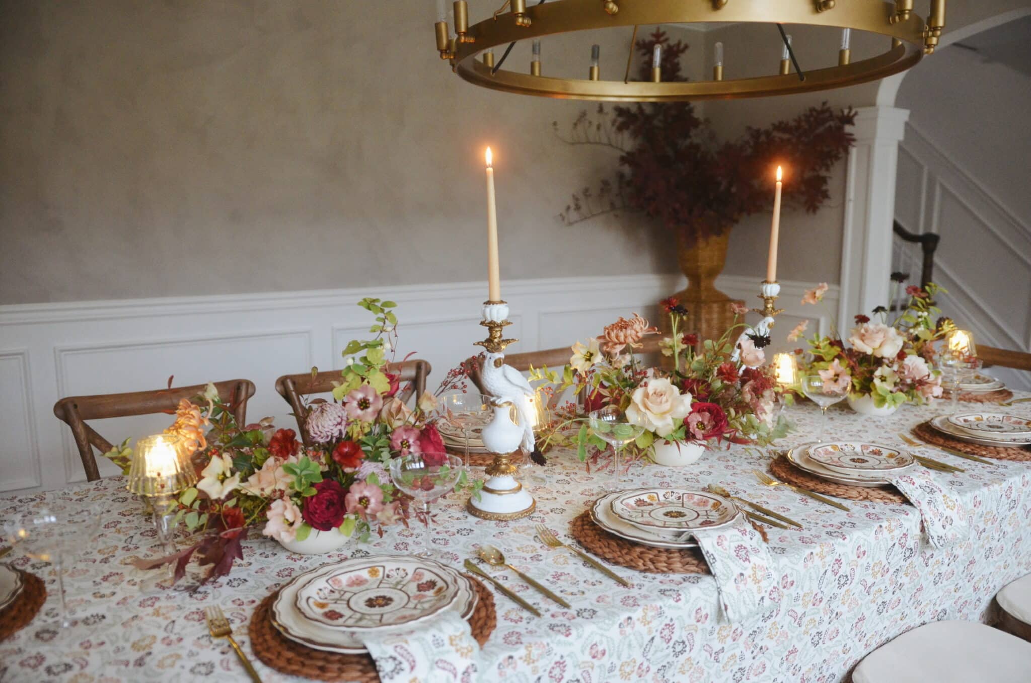 Friendsgiving tablescape with mixed prints, fall flowers, and placemats.