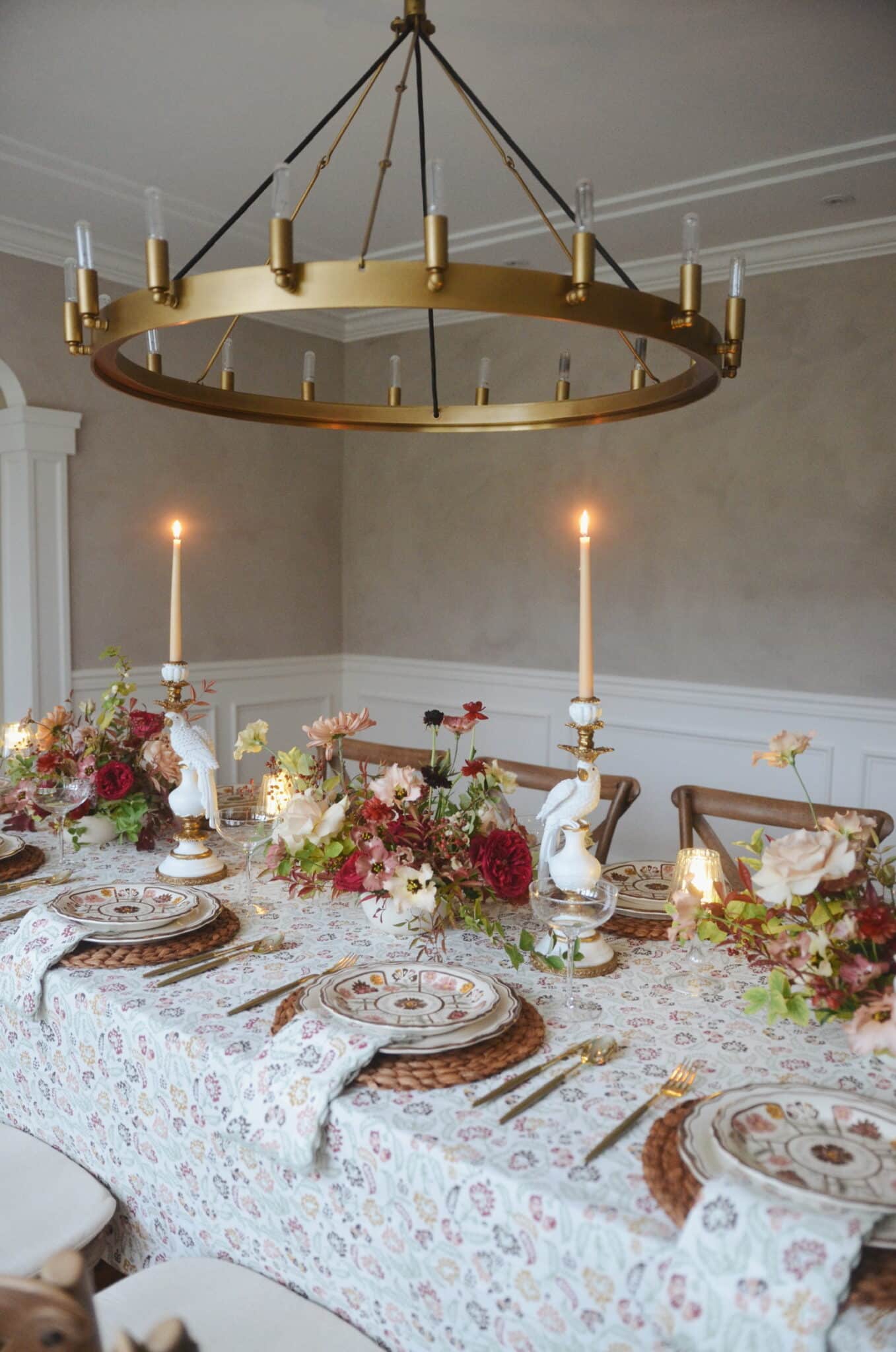 Friendsgiving tablescape with mixed prints, fall flowers, and placemats.