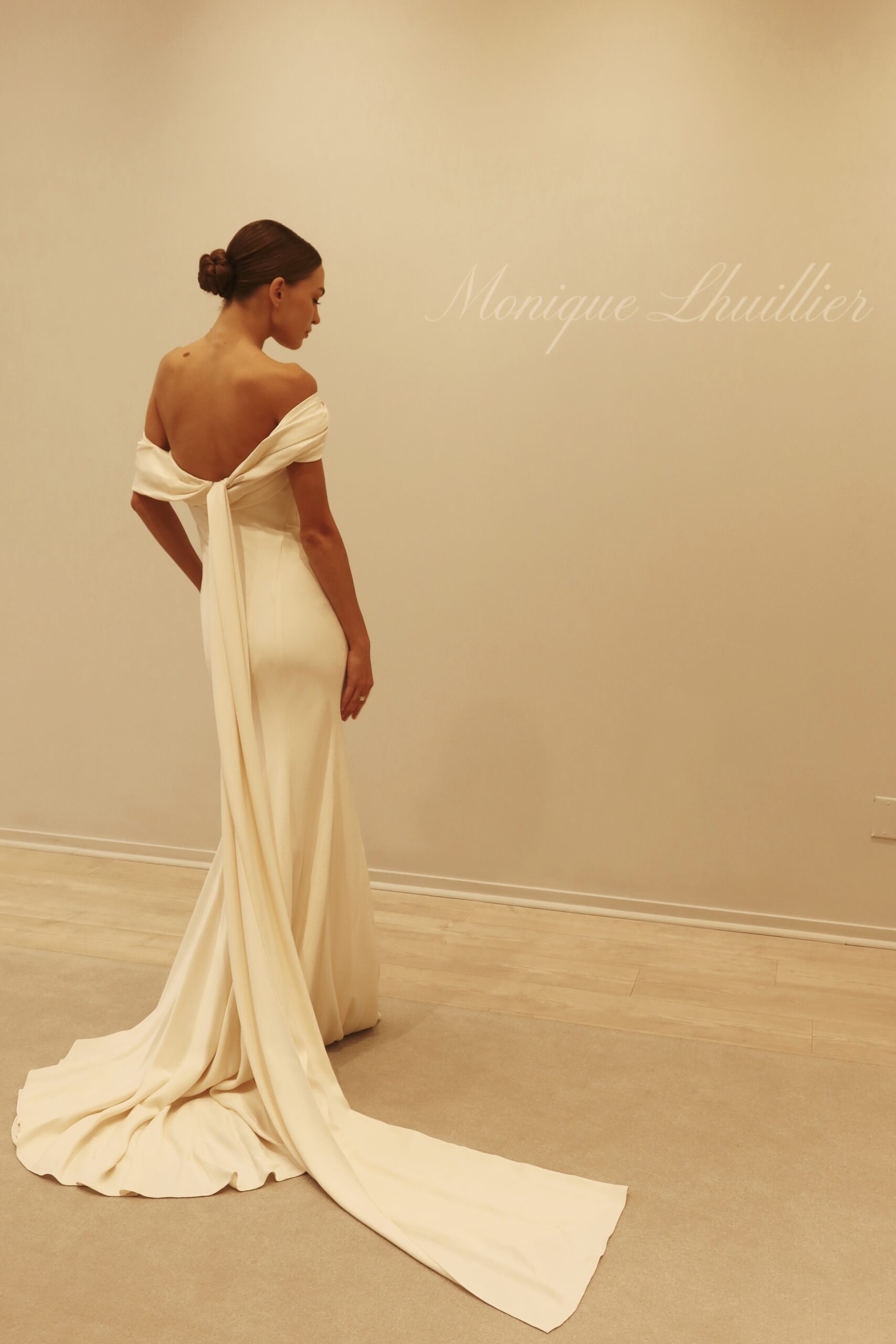 Rowe wedding gown Hammered Crepe sheath gown with asymmetrical draped neckline.
