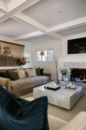 modern living room with oversized marble coffee table and blue tile mantel